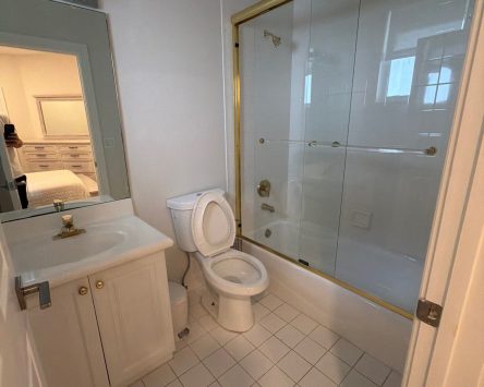 Small bathroom remodel with white tile, glass shower enclosure, and vanity in Palm Beach County